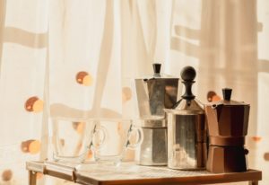 Moka pot and cups on table