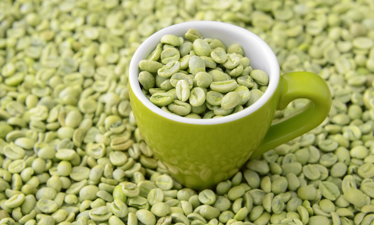 Green coffee beans in a green cup.